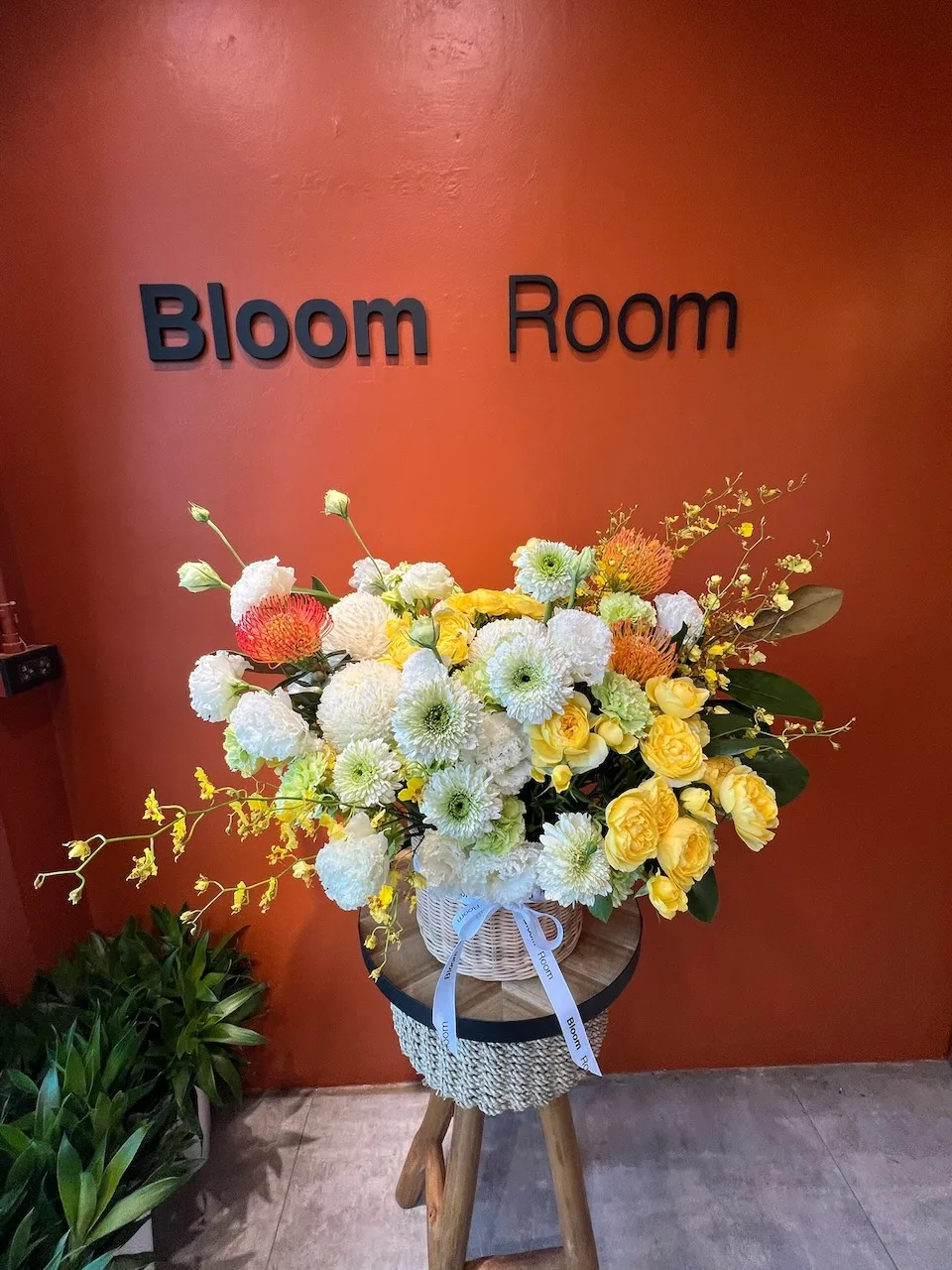 Tall stand arrangement with yellow and white chrysanthemums, oncidium orchids and orange gerberas