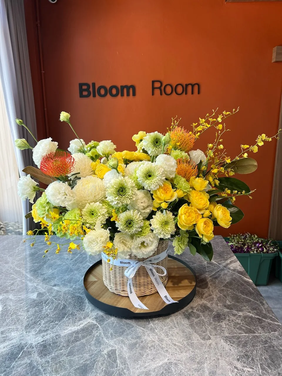 Yellow, white and orange basket arrangement with chrysanthemums and oncidium orchid