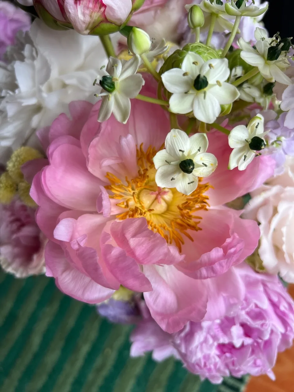 Close-up of a romantic bouquet with pink peonies, white ornithogalum and soft pastels
