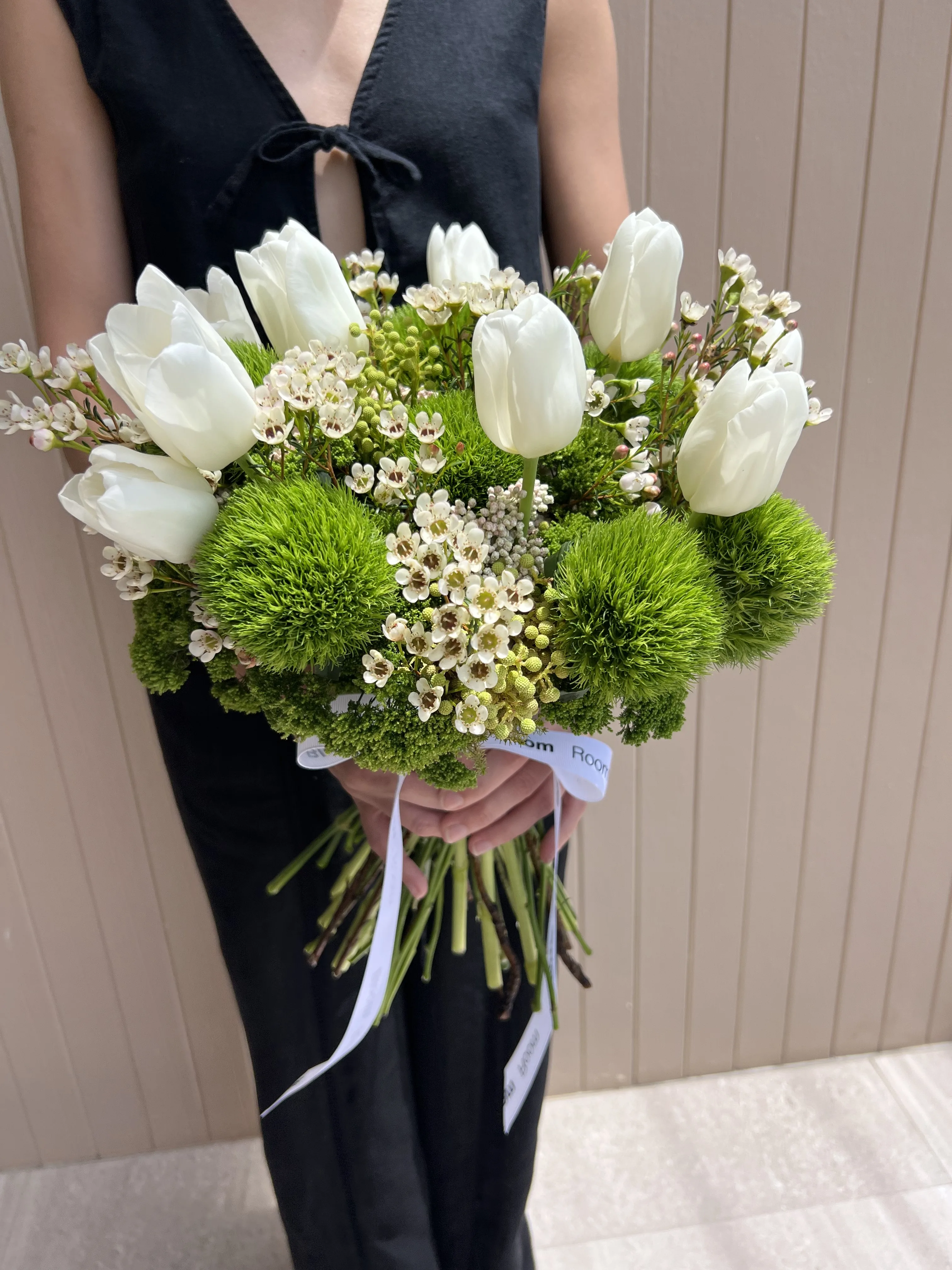 Bridal bouquet of white tulips, green dianthus and waxflower tied with Bloom Room ribbon