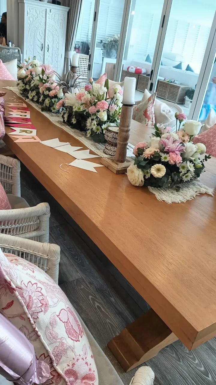 Long pastel pink table runner of centerpieces with candles