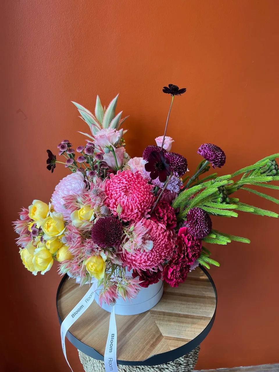 Bloom Room box with pink dahlias, yellow blooms, a mini pineapple and snapdragon accents