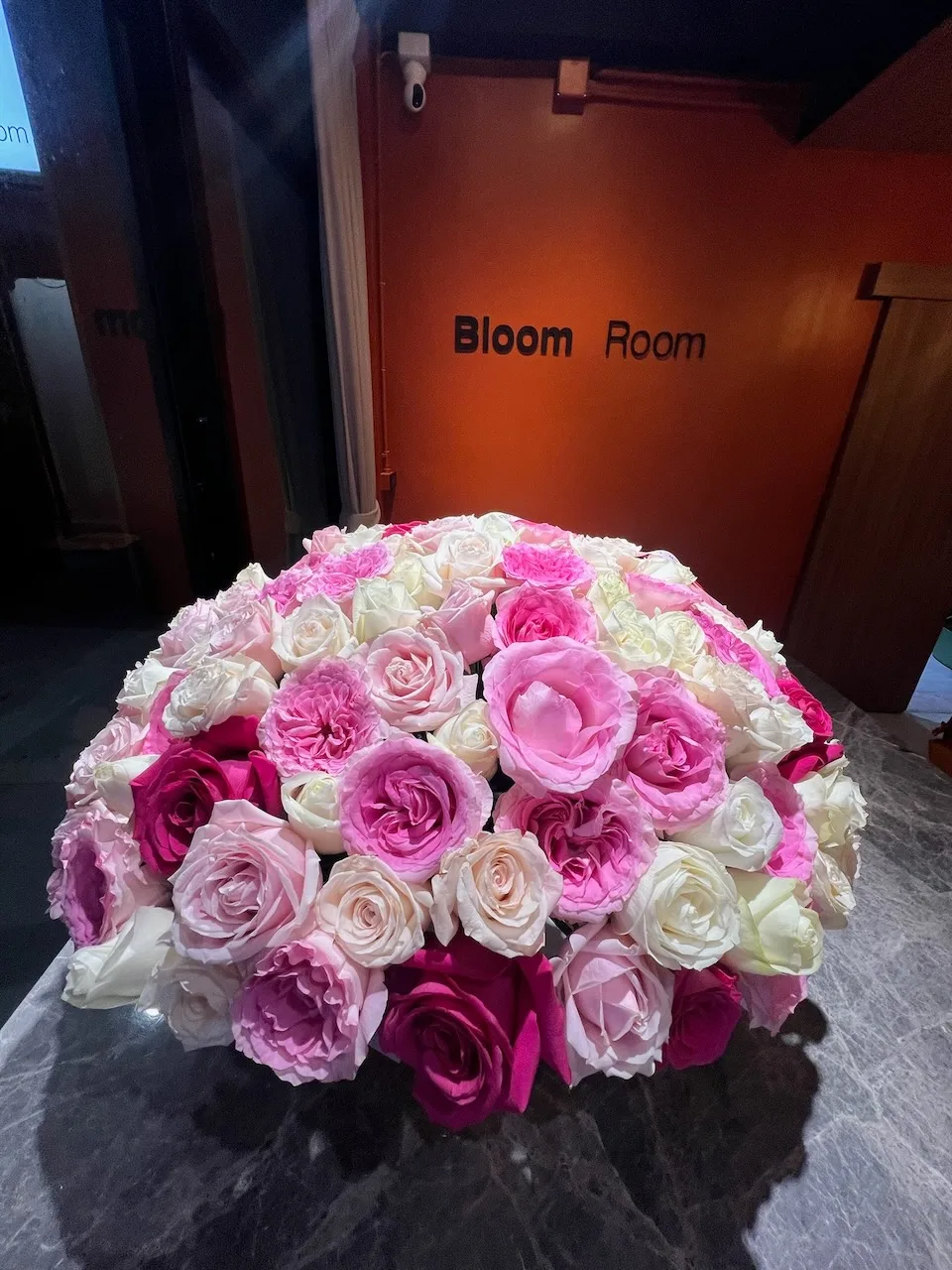 Dome of pink and white roses in a Bloom Room box at the studio entrance