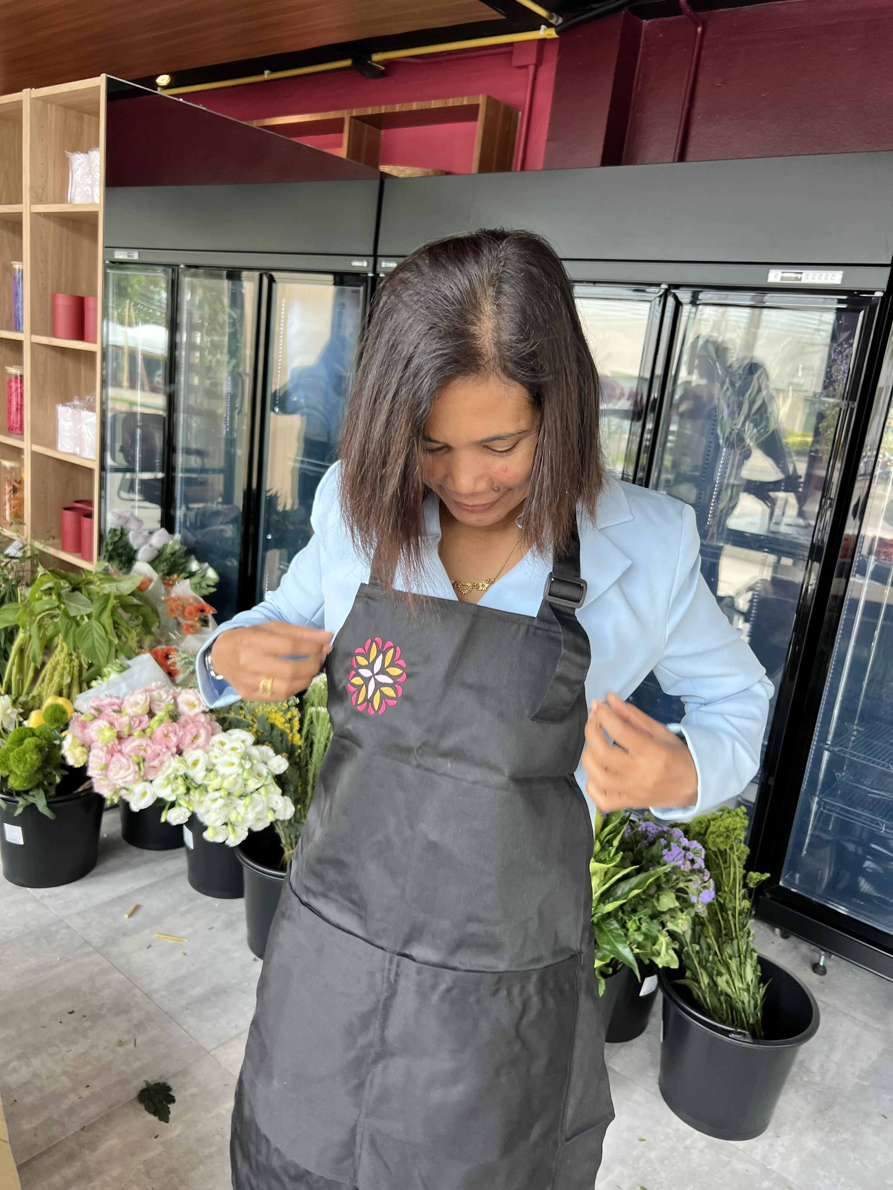 A Bloom Room Studio florist in apron at the studio workbench